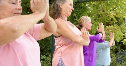 Senior Women Practicing Yoga Outdoors in Natural Setting