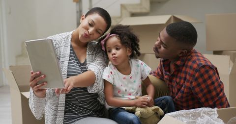 Family Using Tablet While Moving into New Home - Download Free Stock Images Pikwizard.com