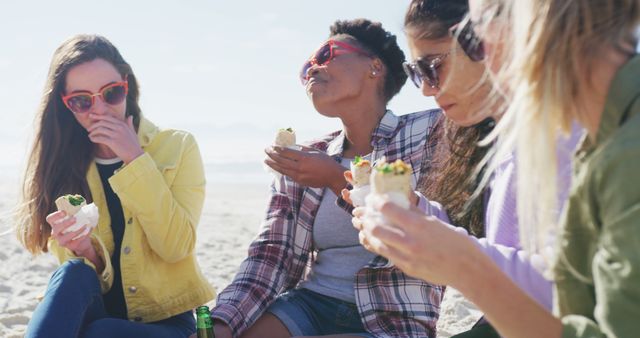 Group of Diverse Friends Eating Wraps and Relaxing at Beach - Download Free Stock Images Pikwizard.com