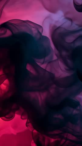 Vertical video: dark ink swirling in pink water creating abstract fluid motion background