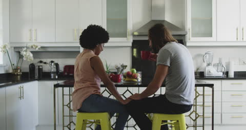 Couple Relaxing with Coffee in Modern Kitchen