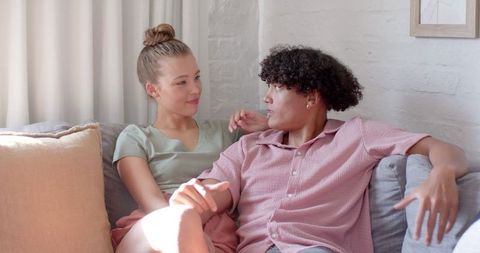 Relaxed Couple Sitting Close on Minimalist Sofa in Living Room