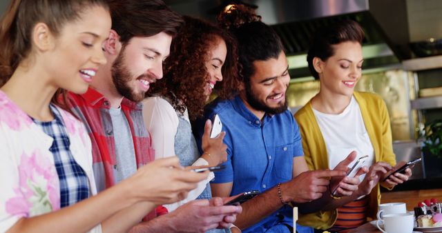 Diverse group of young adults enjoying smartphone conversation - Download Free Stock Images Pikwizard.com