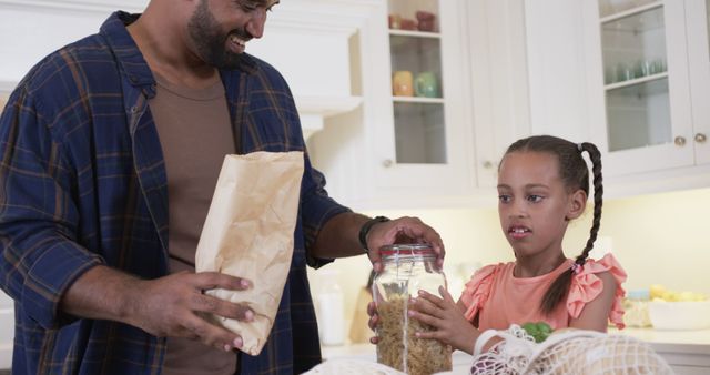 Father and Daughter Storing Cereal in Kitchen - Download Free Stock Images Pikwizard.com