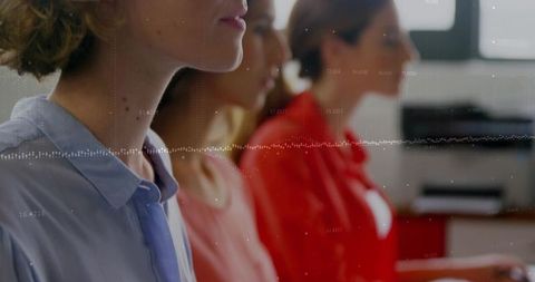 Three women listening at office meeting with data waveform overlay and team collaboration