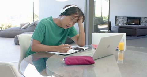 Focused Student Using Tablet for Writing While Listening to Audio - Download Free Stock Images Pikwizard.com
