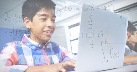 Schoolboy Enthusiastically Using Laptop with Mathematical Equations Overlay
