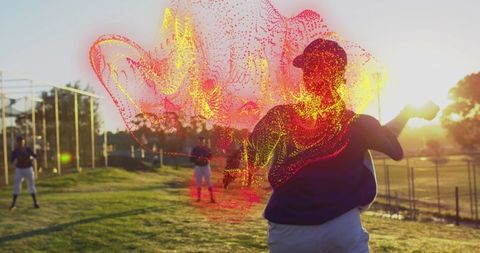 Female baseball pitcher throws ball at sunset training session