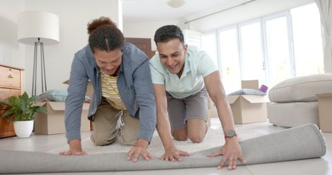 Happy Male Partners Preparing New Home Together
