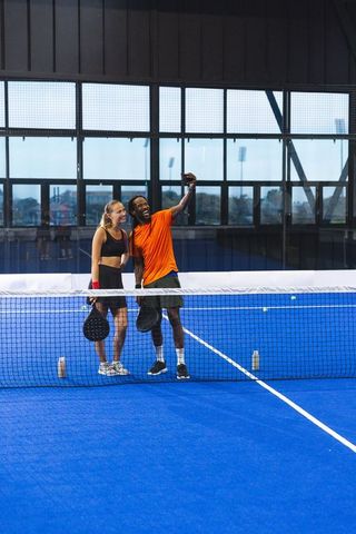 Diverse Friends Taking Selfie on Indoor Padel Court After Match