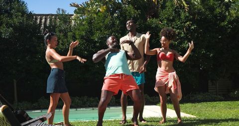 Diverse Friends Dancing by Poolside During Vibrant Summer Gathering