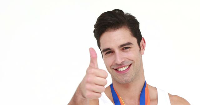 Man Celebrating Success with Thumbs Up and Medal - Download Free Stock Images Pikwizard.com