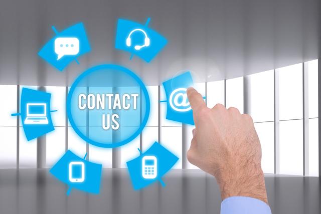 Image features a hand pointing at a 'Contact Us' graphic surrounded by various communication icons including email, phone, and headset. Suitable for representing customer service, online support, technological solutions, business communication, and reaching out for assistance.