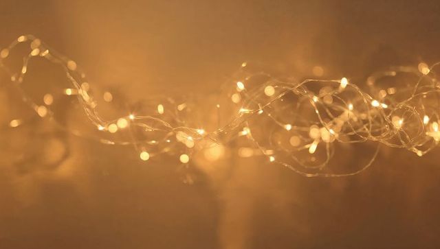 Warm Golden Fairy Lights String Creating Soft Bokeh Glow for Holiday and Ambient Backgrounds