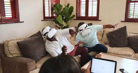 Friends Using VR Headsets for Virtual Reality Experience at Home