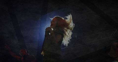 Energetic Female Singer Performing with Passion on Stage