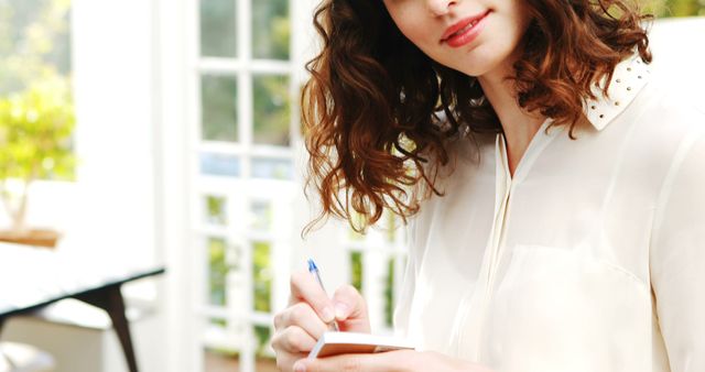 Young Woman Writing Notes in Sunny Room - Download Free Stock Images Pikwizard.com