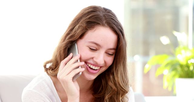 Smiling Woman Chatting on Smartphone at Home - Download Free Stock Images Pikwizard.com