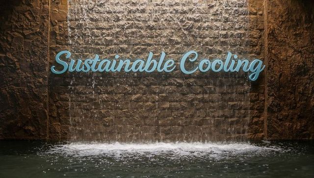 Turquoise sustainable cooling script sign flowing waterfall wall feature in modern atrium