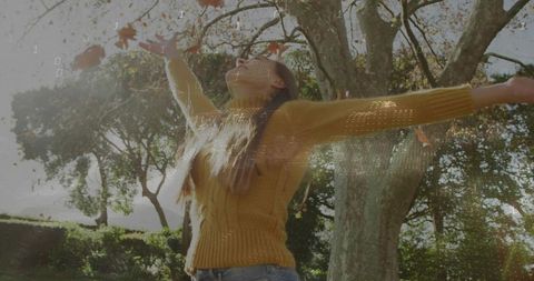 Woman in Sweater Enjoying Serenity Amidst Falling Autumn Leaves