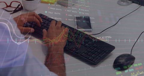 Hands on Keyboard Overlaid with Financial Data Charts