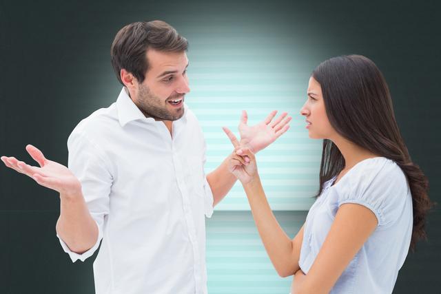 Young couple standing indoors, actively discussing something, appearing to have an argument or serious discussion. Ideal for articles on relationships, communication issues, conflict resolution, emotional expression, and young adult interactions.