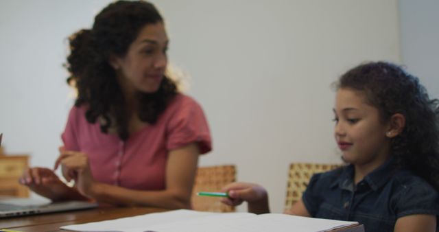 Happy Biracial Mother and Daughter Doing Homework at Home Showing Family Bonding - Download Free Stock Images Pikwizard.com