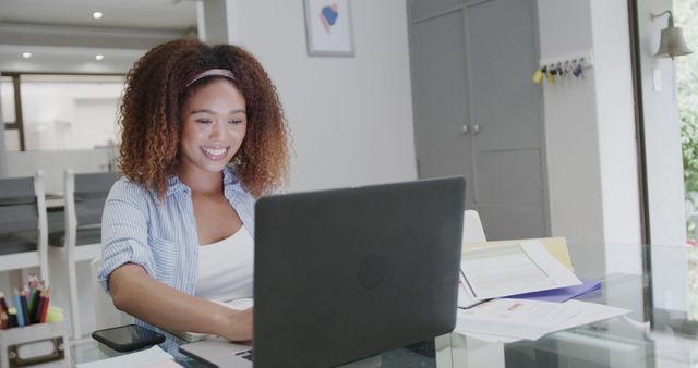 Woman Smiling While Working on Laptop at Home Office Table - Download Free Stock Images Pikwizard.com