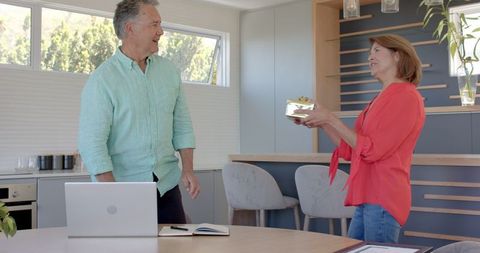 Senior Couple Celebrating with Framed Certificate at Home