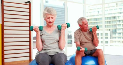 Senior Couple Exercising with Dumbbells in Fitness Center - Download Free Stock Images Pikwizard.com