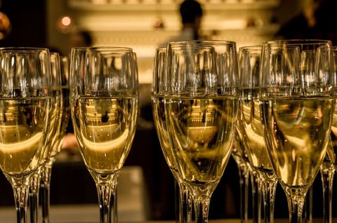 Sparkling champagne flutes reflecting warm golden lights for celebration