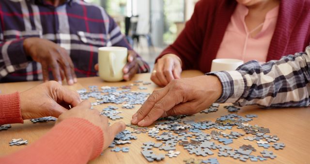 Senior Friends Enjoying Puzzle Game Together at Cozy Café - Download Free Stock Images Pikwizard.com