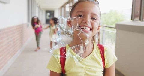 Smiling schoolgirl wearing yellow tee and red backpack straps with white doodle overlay