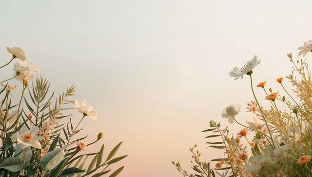 Pastel sunrise wildflowers blooming along meadow edge, white and peach blooms glowing