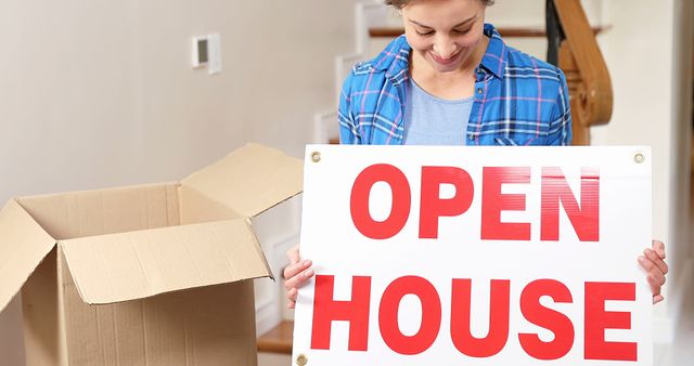 Woman Unpacking Box Holding Open House Sign in New Home - Download Free Stock Images Pikwizard.com