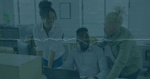 Collaborating team leaning over laptop with digital waveform overlay in modern office