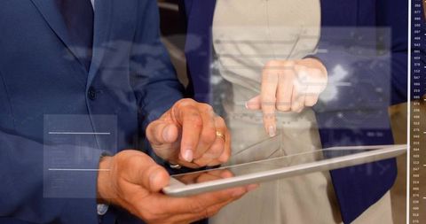 Senior executives collaborating on tablet displaying augmented data dashboard and analytics