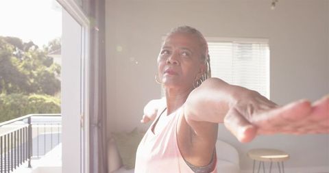 Senior African American Woman Stretching in Sunlit Room