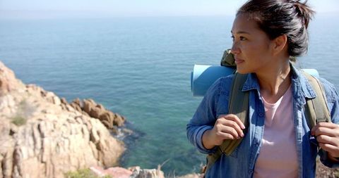 Woman Enjoying Ocean Cliff Views During Hike Adventure
