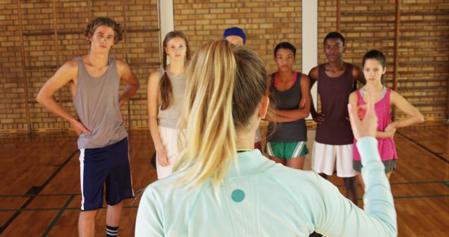 Diverse Group of Teenagers Receiving Instructions from Coach in Gym - Download Free Stock Images Pikwizard.com