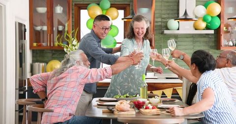 Senior Friends Celebrating Together at Dinner Party