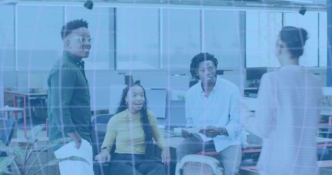 Young Professionals Brainstorming in Open Office Collaborating Around Desks and Monitors