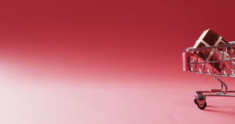 Mini Shopping Cart with Gift on Red Background