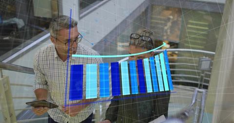 Discussing business analytics on mezzanine using tablet and rising blue bar chart overlay