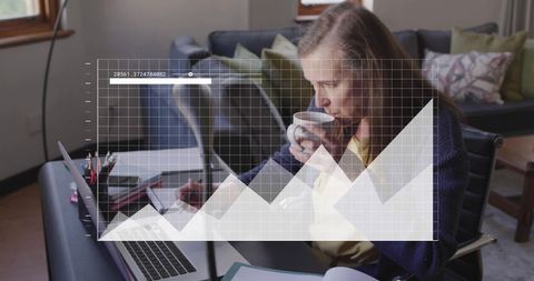 Senior Woman Analyzing Financial Data on Laptop at Home Office