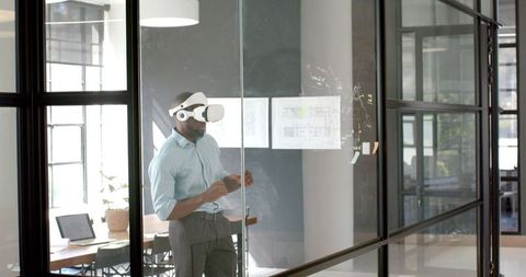 Business Professional Engaging with Virtual Interface Using VR Headset