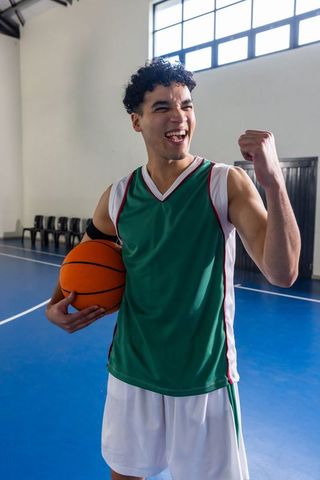 Triumphant Basketball Player Celebrating Victory on Indoor Court