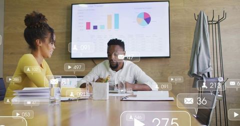 Reviewing charts in boardroom colleagues collaborating on data with social media overlays