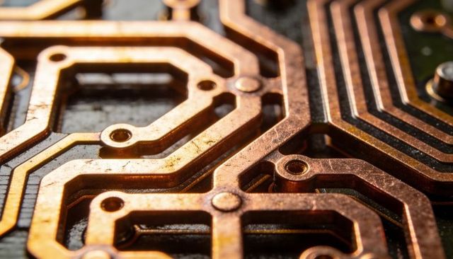 Macro Closeup Showing Raised Copper Traces and Solder Pads on PCB with Vias and Tarnish