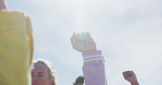 Unified Protest Fists Raised Against Sunny Sky - Download Free Stock Images Pikwizard.com